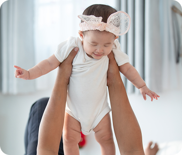 happy-asian-family-father-with-baby-daughter-playing-bed-with-smile-face