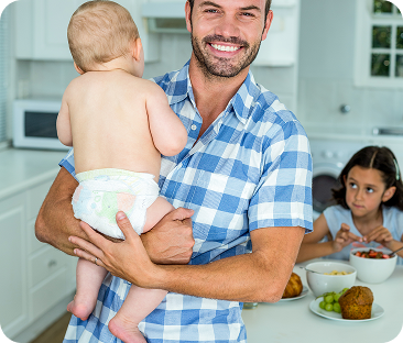 happy-father-carrying-son-with-daughter-having-breakfast